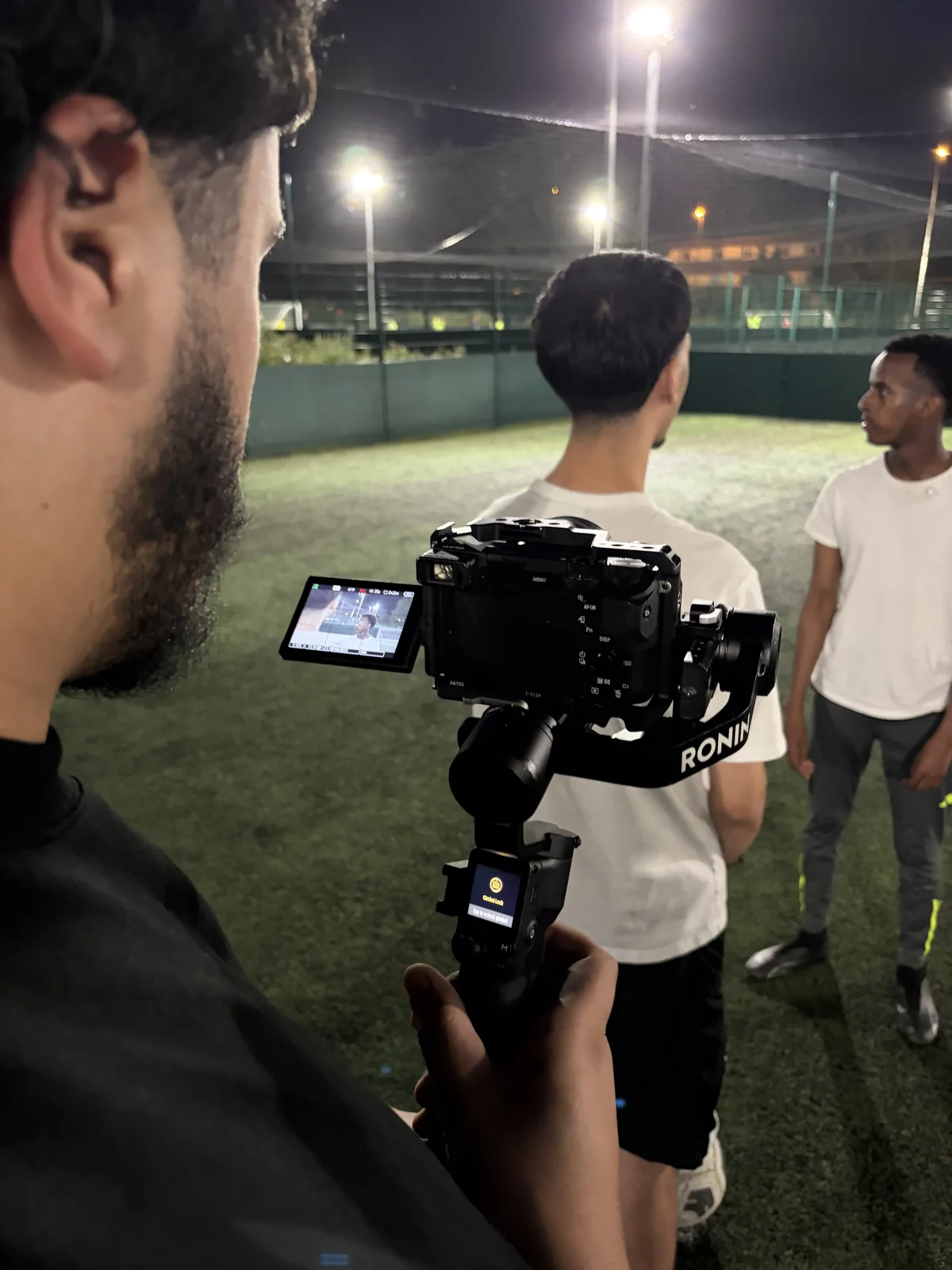 A ZeroPoint camera operator filming a group on location at Unity Cup.